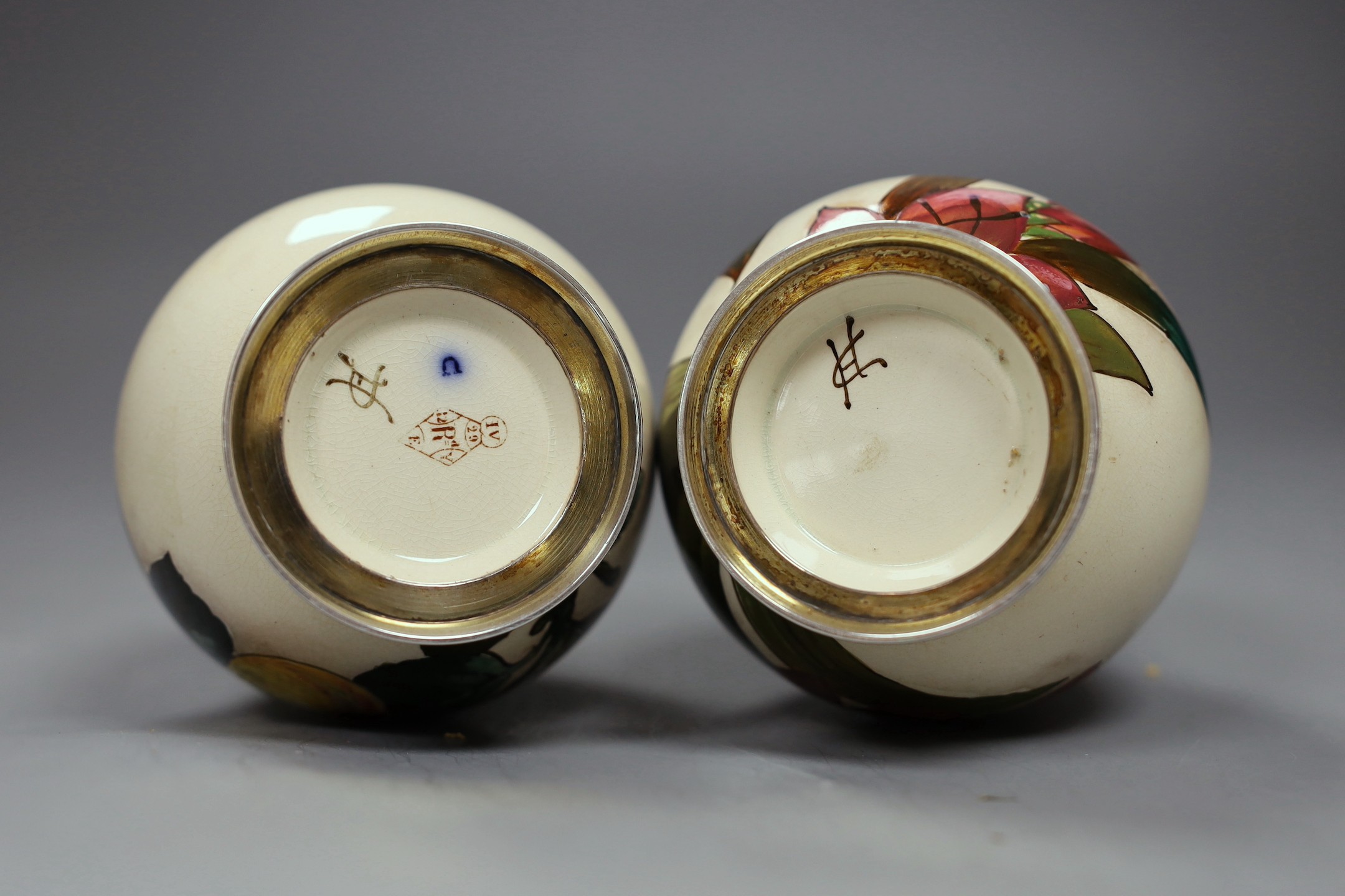 A pair of Victorian silver mounted Art pottery scent bottles, 21.5cms high including stopper